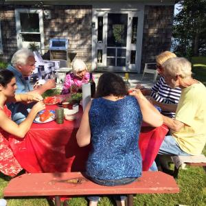 The Thayer clan and cousin Rich have a lobster feed at the cottage on the Fourth of July. SUZI THAYER/Boothbay Register