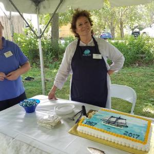 President Kathy Tibbetts, left, checks in with trustee Sarah Giles, who handed out cake and ice cream to visitors at the Aug. 6 celebration. KATRINA RICKERMANN/Boothbay Register