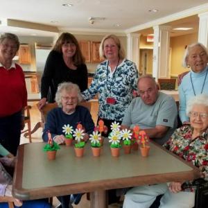 BRGC Garden Therapy team members, Activity Director Jerie Phinney, and Gregory Wing residents are all smiles as they display this month's garden therapy project. Courtesy of Kathleen Marty