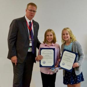 Dan Ducker, the associate director of the VA Maine Health Care Systems, presents a Certificate of Appreciation to Magen Burge (center) and Lilly Nein. Courtesy photo