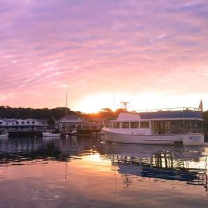 The sun comes up over Boothbay Harbor Oct. 6, as the Novelty heads out on its first trip of the day. STEVE EDWARDS/Boothbay Register