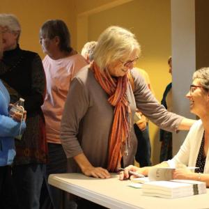 Laurie Apgar Chandler, right, author of the newly released adventure memoir “Upwards” visits with readers Lisa Hagen and Paula Campbell during the Oct. 29 book launch celebration at Skidompha Library. Courtesy of Hannah McGhee