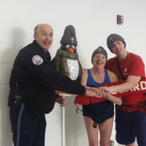 Boothbay Harbor Police Officer Larry Brown and two members of the Y aquatic staff, Irene Hutchinson and Daniel Parrott, hold hands to encourage would-be Penguin Plunge participants. Courtesy photo