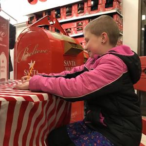 Madison Lorrain found out her wish to go to Disney World will be granted by Make-A-Wish Maine at Macy’s in Portland on Dec. 8. She then had a mini shopping spree for her trip at Macy’s and wrote a letter to Santa. Courtesy photo