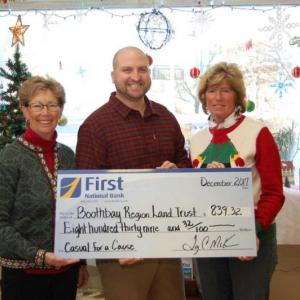 First National Bank’s Denise Griffin, vice president/human resources, and Brenda Blackman, vice president/branch manager, present a check to Nick Ullo, executive director of BRLT. Courtesy photo