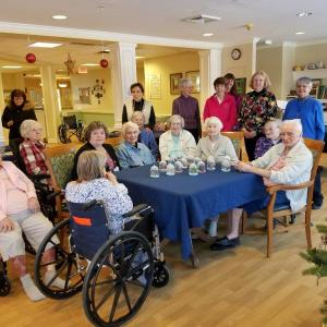 Members of the Boothbay Region Garden Club garden therapy team with residents of the Gregory Wing and Safe Havens creating snowy woodland cloches. Courtesy of Kathleen Marty