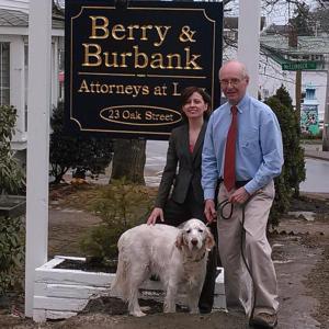 Meegan Burbank and Tom Berry show the sign for their newly announced law firm as their four-legged associate Oliver assists. JANE CARPENTER/Boothbay Register