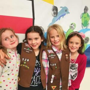 Some of the Brownies from Troop 526 stand in front of their cookie sale banner. From left are Annabelle Whitney, Gigi Blake, Arabella Hodgdon and Olivia Carlson. Courtesy of Tonia Blake