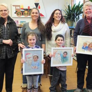Artist Sue Heil Kibbe, far left, shares a Kodak moment with the kids in her “Santa Series” portraits completed two years ago and their family members. Front, from left: Lilly Brown and Hunter McDaniel; back, from left: Heil Kibbe, Cody Orne, Heather McDaniel and Sally Barter. LISA KRISTOFF/Boothbay Register