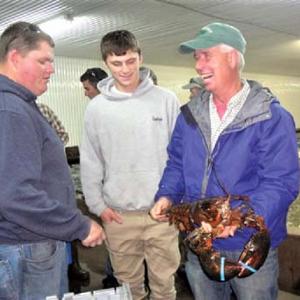 David Cousens, right, with two young Maine lobstermen. Courtesy of the Maine Lobstermen’s Association