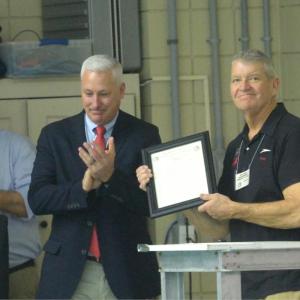 High school swim coach Don Strout is honored at the 2018 state meet. The Class A and Class B meets were dedicated to Strout for his 25 years of coaching and support of student athletes. Courtesy of Earl Brewer