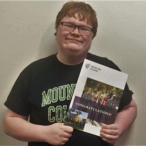 BRHS senior Tyler Field holds his acceptance packet from Mount Ida College. JOSEPH CHARPENTIER/Boothbay Register