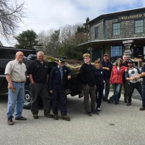 Some of the community cleaners pose before a dump truck load of trash before it heads to the dump. Courtesy of the Boothbay Region Water District.