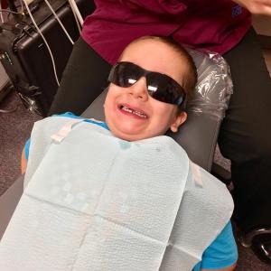 Caleb Stover, 5, poses in the dentist chair. The glasses are for protection, and to make Caleb feel cool. SUZI THAYER/Boothbay Register