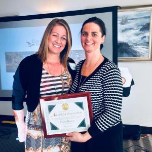 Haley Bezon, left, is awarded the first ever Annual Award for Innovation, by Coulombe Center Program Manager Anni Pat McKenney on May 21 at the Oceanside Gold Resort in Boothbay Harbor. SUZI THAYER/Boothbay Register