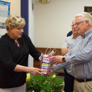 Jane Good receives a gift from Board of Directors President Shawn Lewin as Dwight Lewis, center right, looks on. Courtesy of Bob Crink