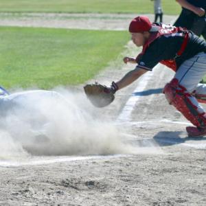 Boothbay’s Cameron Crocker slides under the tag of Wolverine catcher Andrew Hendrickson after hitting an inside the park home run in the first inning. PHIL DI VECE/Wiscasset Newspaper