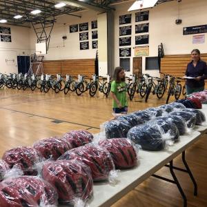 Meredith Ames, the top BRES reader, gets ready to choose a bicycle helmet during the assembly where participating students received bicycles and helmets from the Bay View Masonic Lodge for reading. PAGE BROWN/Boothbay Register