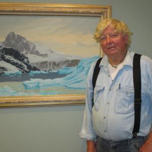 Rusty Court in front of one of dad Lee Court’s paintings, “Antarctica.” Courtesy of Hilary Bartlett
