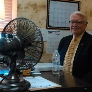 Community Center board president Shawn Lewin uses a fan to keep cool while he and fellow board members hope for donations for a new HVAC compressor. JANE CARPENTER/Boothbay Register