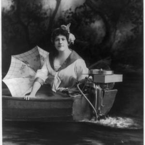 A woman poses with a 1913 Evinrude to demonstrate the ease and enjoyment of outboard motors. Photo: Library of Congress