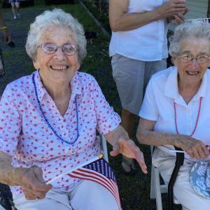 Fourth of July Parade honorees Evelyn Sherman, left, and Jean Thompson, sit in the shade before riding in Jim Singer’s convertible. ISABELLE CURTIS/Boothbay Register