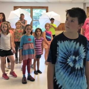 Trey Tibbetts of Southport leads the YMCA Music Theatre Camp in the opening number of Mary Poppins JR, playing the role of Bert. Courtesy of Emily Mirabile