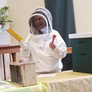 Beekeeper Linda Redman demonstrates the tools used for beekeeping. Courtesy of Carole Zalucky