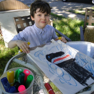 Graham Burke of Newcastle and his dinosaur decorated shopping bag at last month’s ArtWalk. Courtesy of Grace Goldberg
