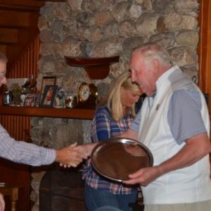 Eric Hakanson, left, congratulates Don Snyder as he accepts the Alden Reed Memorial Trophy from Alex Herger, president of the Boothbay Harbor One Design Association. Courtesy of Debora Snyder