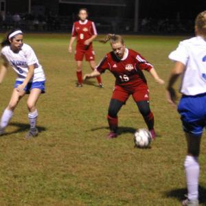 Kateleen Trask with the ball. To her left is Boothbay Region’s Reagan Cola and #3 Katy Nein. PHIL DI VECE/Wiscasset Newspaper
