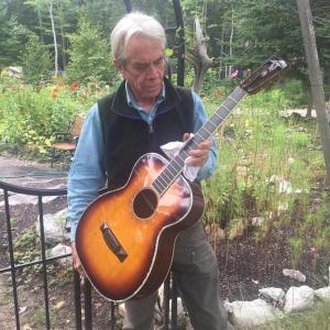 Rob Dmitrieff shines up one of his Big Wave Guitars Orchestra Models (OM) for the exhibition. LISA KRISTOFF/Boothbay Register Maine luthier Rob Dmitrieff