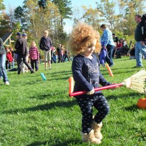 India, 2, of Portland in the Apple Broom Race, one of eight games, in the Great Pumpkin Hunt event at Coastal Maine Botanical Gardens Oct. 20. LISA KRISTOFF/Boothbay Register The Great Pumpkin Hunt at Coastal Maine Botanical Gardens Oct. 20.