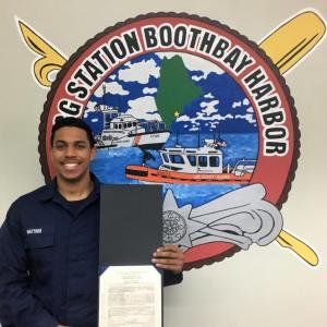 Fireman Elijah L. Wattree is shown with his citation after being named the “Sailor of the Quarter.” That honor is voted on by the station personnel and bestowed on the Coast Guard member who distinguishes himself through exemplary service and dedication. Photo by Bruce MacCormac, Coast Guard Auxiliary