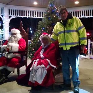 Fire Chief Dick Spofford helps Santa and Mrs. Claus to their seats. MARGARET HOFFMAN/Boothbay Register