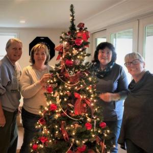 Garden Club members decorate the theme tree, “Merry and Bright.” for the Festival of Trees. From left are Brigitte Smith, Karen Iliades, Irene Fowle and Abbie Shaw. Courtesy of Kathie Trafton