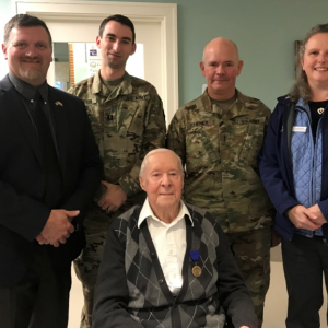 Acting Director, David Richmond from the Maine Bureau of Veterans’ Services, Maine National Guard Historian, Jonathan Bratten, Maine National Guard Command Chief Warrant Officer, David Cheney, and Maine Bureau of Veterans’ Services, Director of Strategic Partnerships, Sarah Sherman, with Corporal West at his World War II Recognition Ceremony. Courtesy of Sarah Sherman