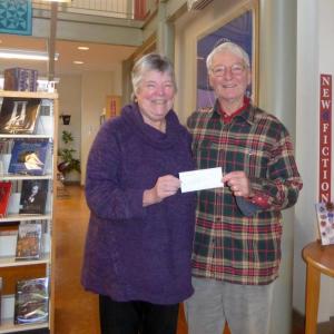 The Pemaquid Group of Artists Vice President Paul Sherman presents a check for renewal of museum pass to the Portland Museum of Art to Pam Gormley, director of the Skidompha Public Library. Courtesy of Peggy Farrell