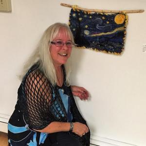 Cathie Stebbins Peterson and her “Starry Night” wall hanging - inspired by Vincent van Gogh's iconic painting “The Starry Night.” Courtesy of PWA Cathie Stebbins Peterson