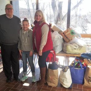Suzie delivering clothes for kids from The Clothing Closet collection on Jan. 2 to Boothbay Region Elementary School. Accepting the donations are BRES Principal Mark Tess and Assistant Principal Trish Campbell. STEVE EDWARDS/Boothbay Register
