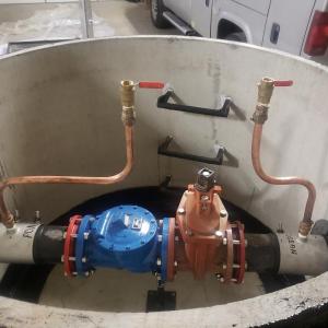 Controls for the siphon, showing a check valve (blue); a large ball valve (orange) and two small ball valves. Merritt Blakeslee photo