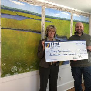 Boothbay Harbor’s Branch Manager Brenda Blackman presents Boothbay Region Land Trust’s Executive Director Nicholas Ullo with a check from First National Bank. Courtesy photo