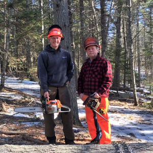 Volunteer Alan Bellows, left, and Lands Manager Michael Warren remove trees in preparation for expanding the parking area at Ovens Mouth West. Courtesy of BRLT
