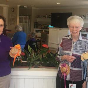 Members of the BRGC garden therapy team, from left, Abbie Shaw, Karen Gilbert, Margaret Holden and Jane Homer, pose in front of one of the newly planted boxes with some of the straw hats created by residents of St. Andrews Village. Courtesy of Vanda Yonge/BRGC