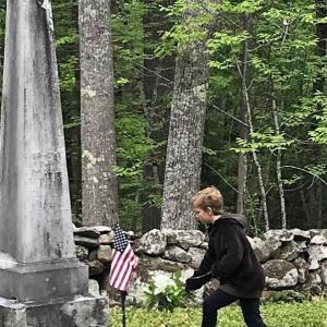 Klea Cunningham of Dresden places a flag at the grave of a fallen soldier during the Memorial Day ceremony in 2018. This year’s event will take place at Pownalborough Court House in Dresden at 11 a.m. on May 27. Courtesy of LCHA