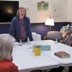 Joan Stark, standing, introduces the VIP group to a recording of deep woods bird songs May 7. JANE CARPENTER/Boothbay Register