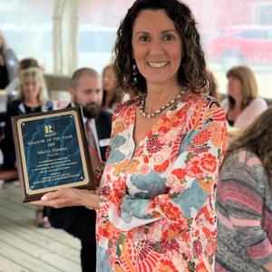 Sherri Dunbar, holding the Realtor of the Year award. Courtesy photo