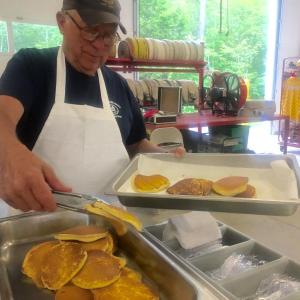 Edgecomb Fire Department member Bill Witzell updates the pancake tray at the auxiliary’s June 29 breakfast at the station. SUSAN JOHNS/Wiscasset Newspaper