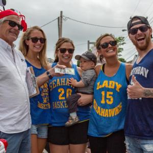 Jack Herger hands the winning prize to cod fish relay race winners, from left, Alexandra Andrews, Lauren Andrews, Kristin Sibley and Brad Bonny. Falene Petrik photo