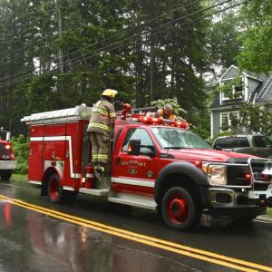 Southport firefighters respond to Lynn Schafer's home after lightning struck it June 30. Robert Mitchell photo